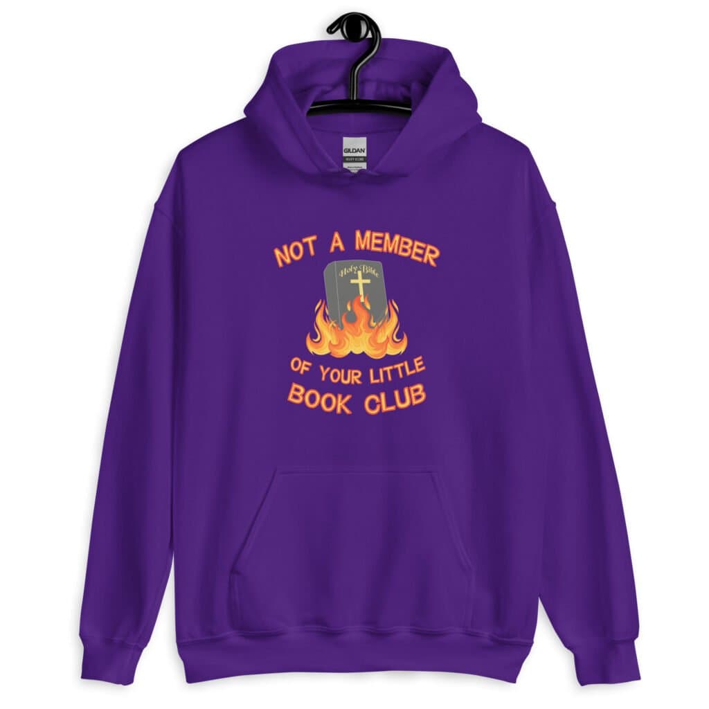Purple hoodie sweatshirt with image of a burning bible and the text 'Not a member of your little book club' printed on the front.