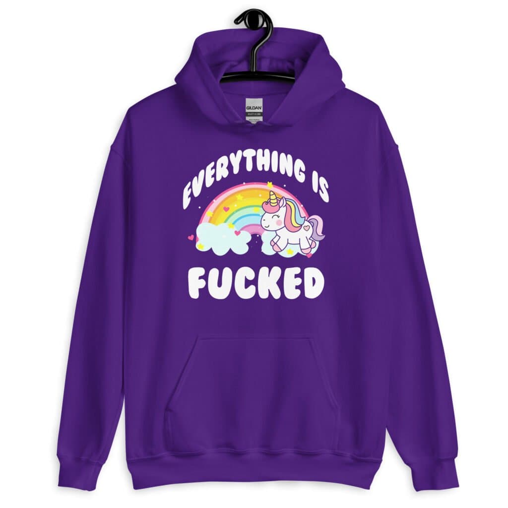 Purple hoodie sweatshirt with a graphic of a kawaii style unicorn and a pastel rainbow with the text 'Everything is fucked' printed on the front.