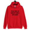 Red hoodie sweatshirt with the funny phrase 'I'm so tired of being my wife's arm candy' printed on the front.