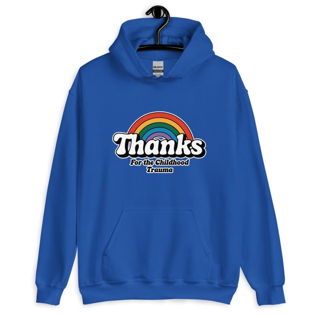 Royal blue hoodie sweatshirt with an image of a rainbow and the words 'Thanks for the childhood trauma' printed on the front. The word Thanks is large and the rest of the words are smaller under.