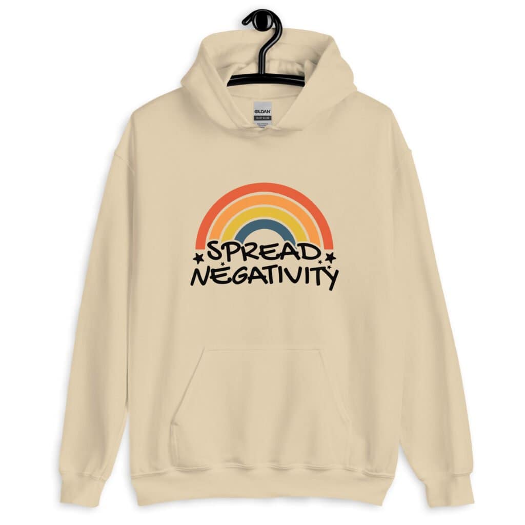 Sand color hoodie sweatshirt with a graphic of a rainbow and the words 'Spread negativity' printed on the front.