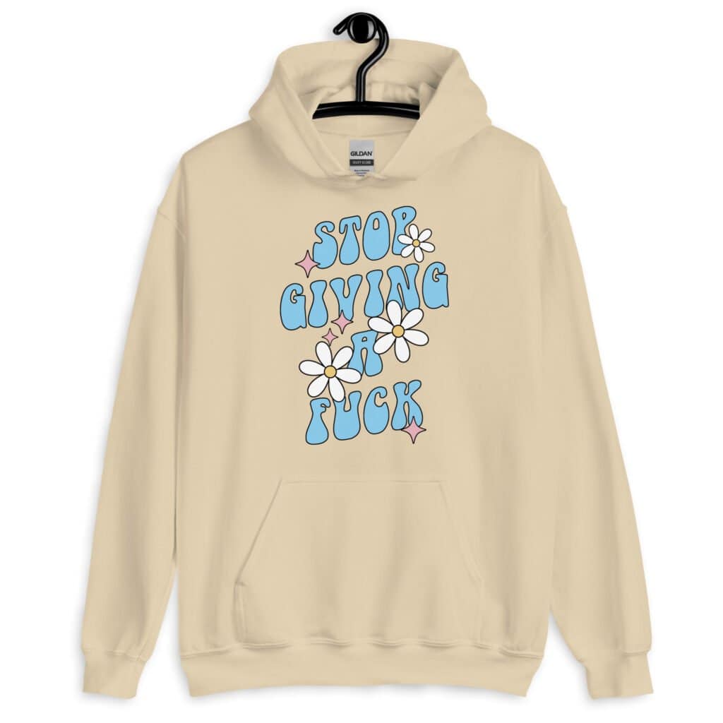 Sand color hoodie sweatshirt with a retro daisy and star design and the text 'Stop giving a fuck' printed on the front.