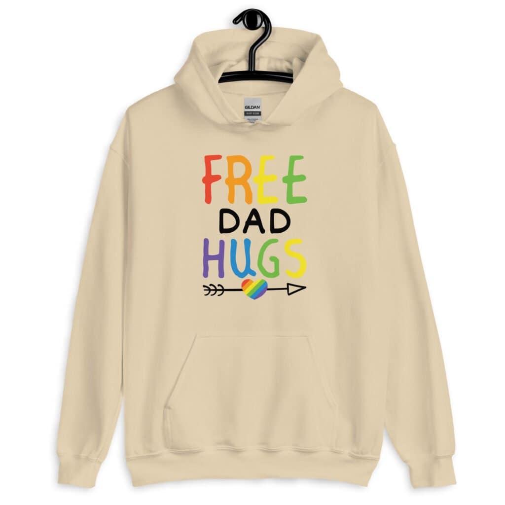 Sand color hoodie sweatshirt with the text 'Free Dad hugs' printed on the front in rainbow letters.