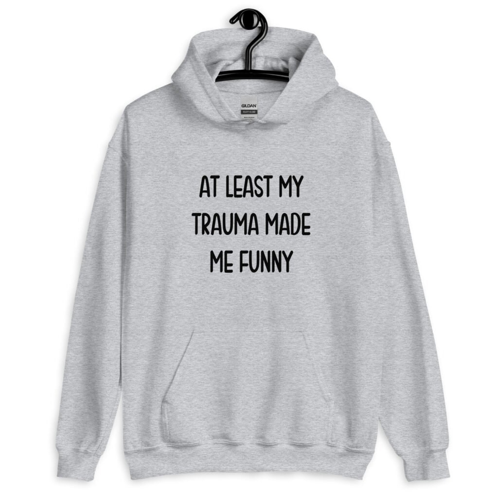 Sport grey hoodie sweatshirt with the text 'At least my trauma made me funny' printed on the front.