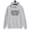 Sport grey hoodie sweatshirt with the funny phrase 'I'm so tired of being my wife's arm candy' printed on the front.