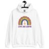 White hoodie sweatshirt with an image of a boho style rainbow. There is an upside down cross in the center arch of the rainbow and the text 'Love like Lucifer' printed under. The graphics are printed on the front.