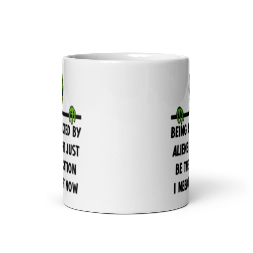 White ceramic mug with image of an alien and the words 'Being abducted by aliens might just be the vacation I need right now' printed on both sides.