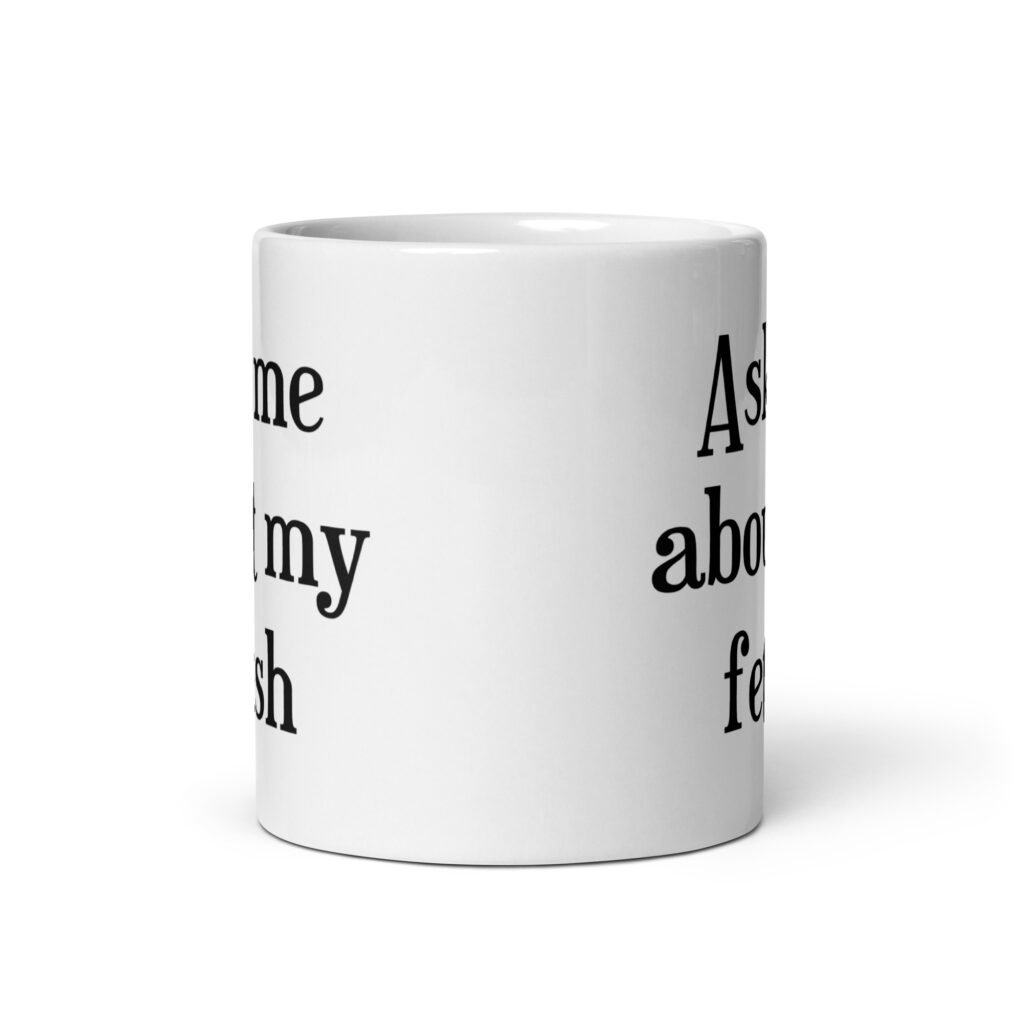 White ceramic mug with the text 'Ask me about my fetish' printed on both sides.