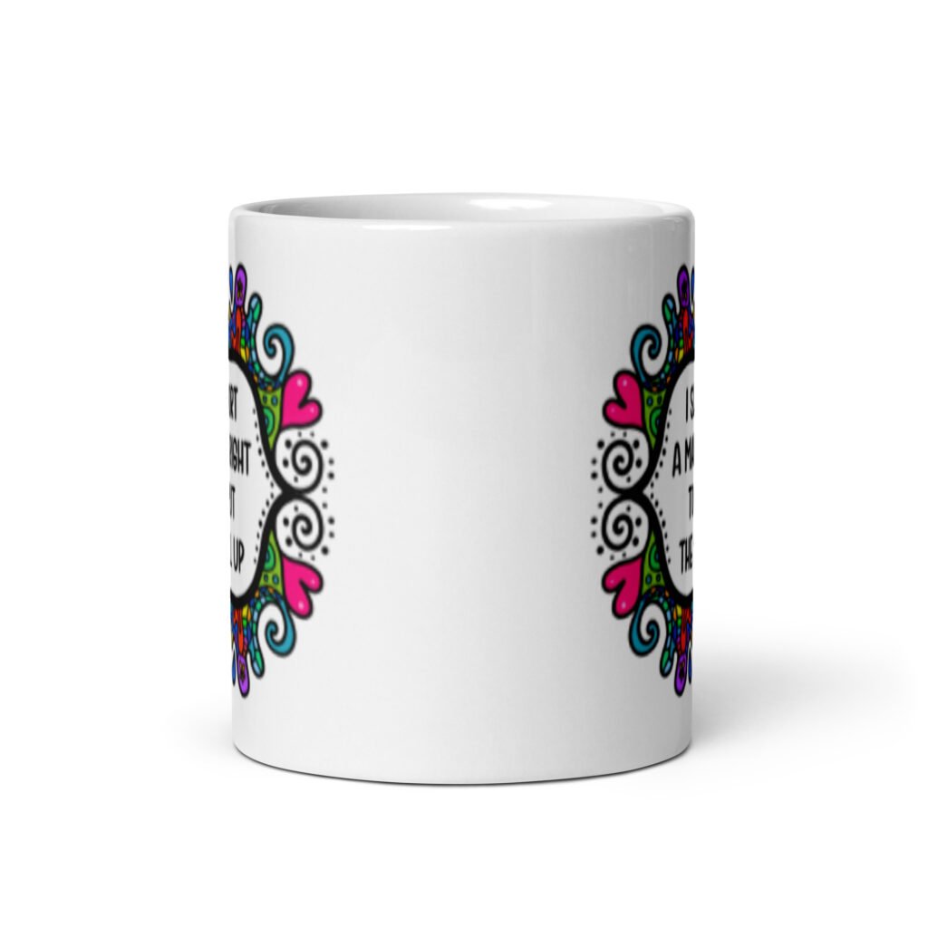 White ceramic mug with a colorful doodle graphic and the words 'I support a man's right to shut the hell up.' The design is printed on both sides of the mug.
