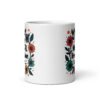 White ceramic mug with a multi color floral wreath design printed on both sides. The words 'One mental breakdown later...' are printed in the center of the wreath.