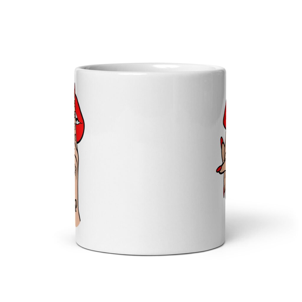 White ceramic mug with an image of a hand over lips making the shh gesture. The words 'Shut the fuck up' are printed on the hand. The graphics are printed on both sides of the mug.