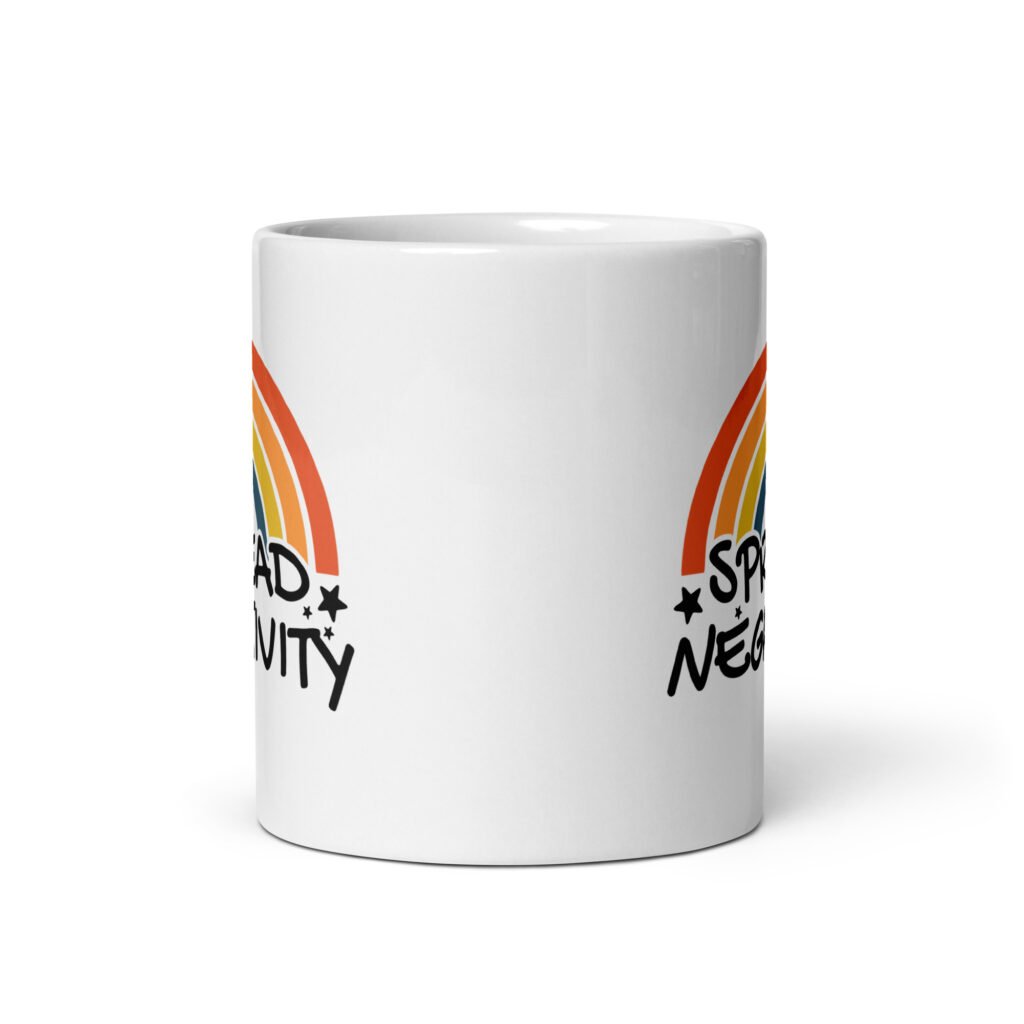 White ceramic coffee mug with a graphic of a rainbow and the words 'Spread negativity' printed on both sides.