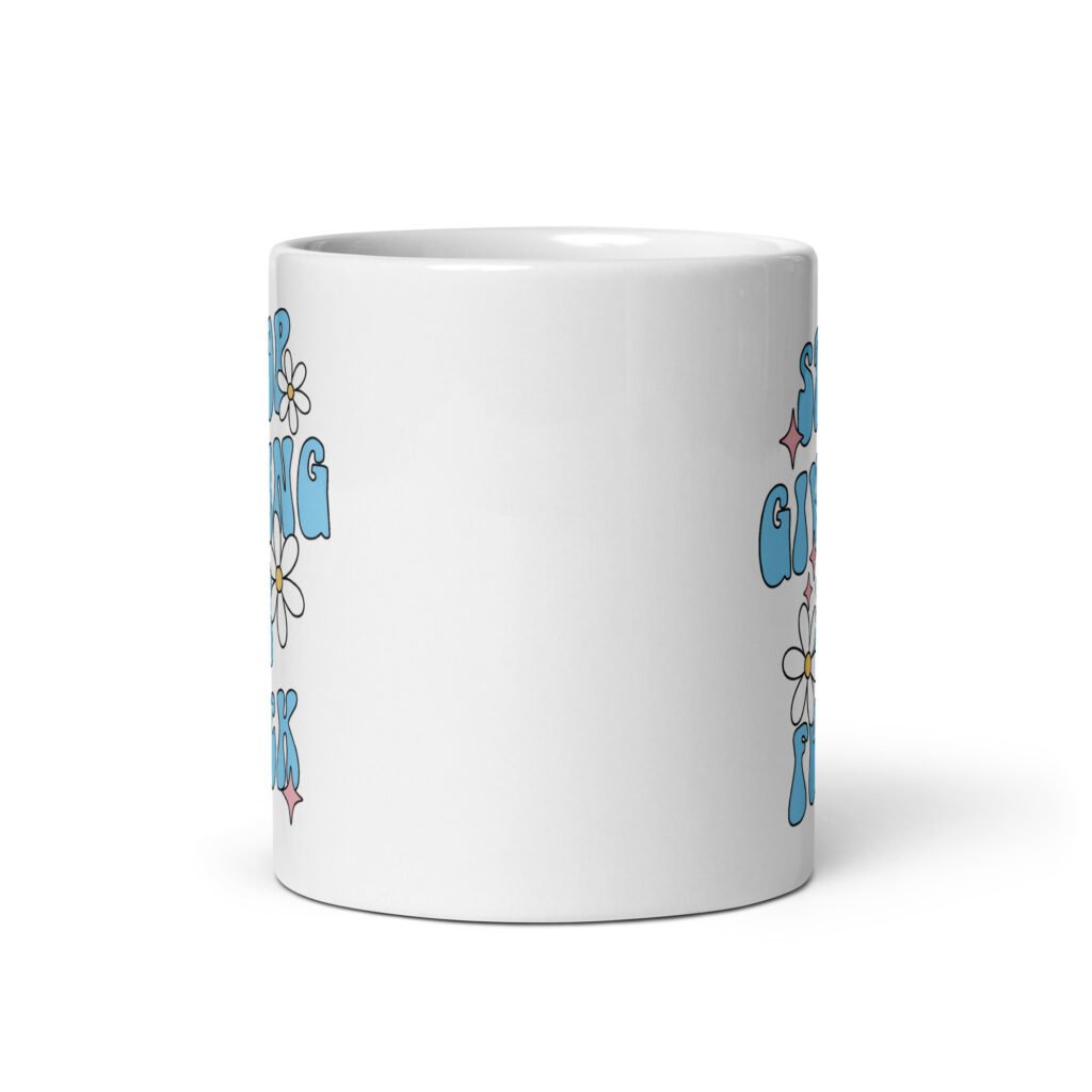 White ceramic coffee mug with a retro daisy and star design and the text 'Stop giving a fuck' printed on both sides.