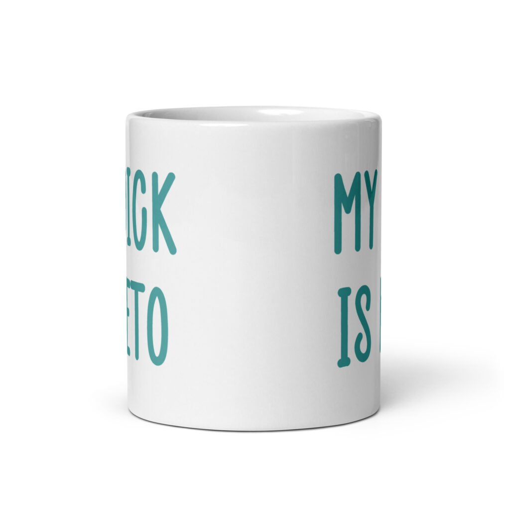 White ceramic coffee mug with the text 'My dick is keto' printed on both sides in turquoise font.