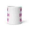 White ceramic coffee mug with the words 'Women don't owe you shit' printed on both sides in pink.