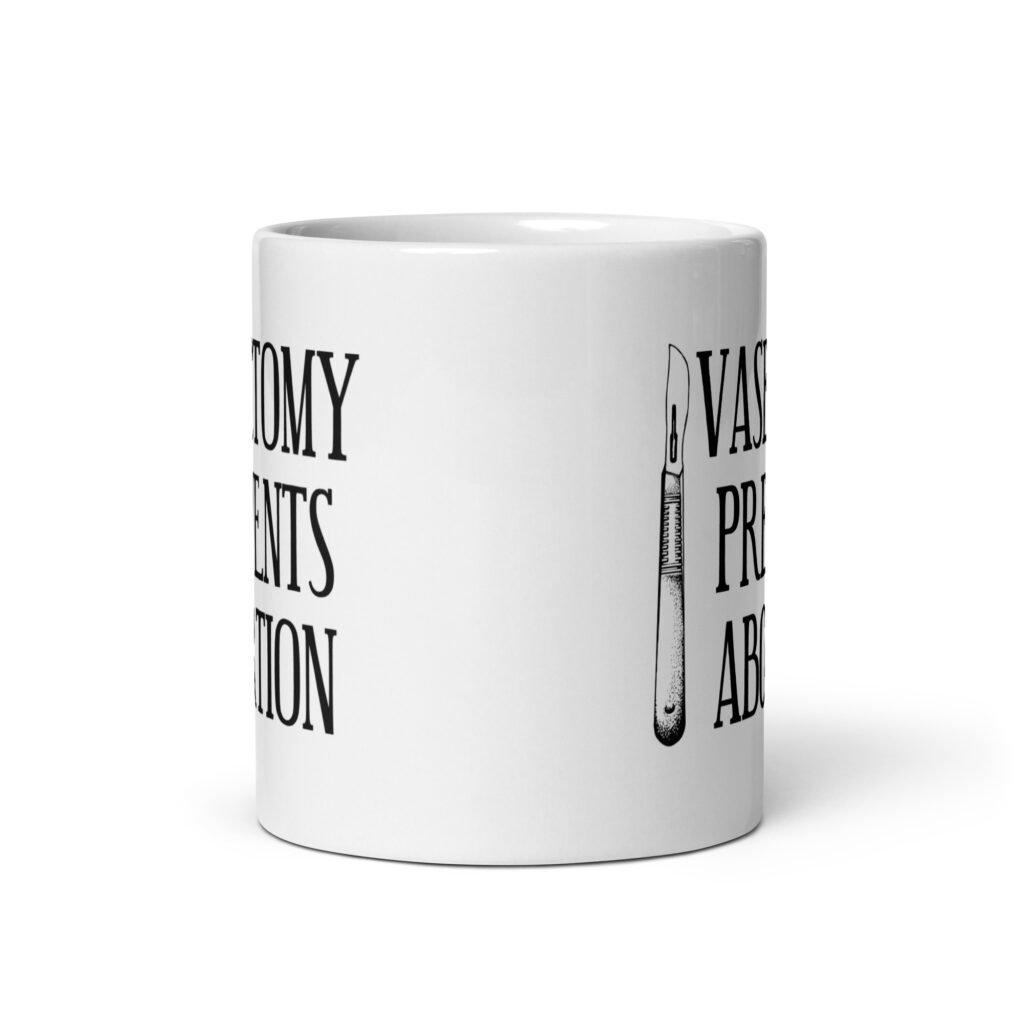 White ceramic coffee mug that has an image of a surgical scalpel and the phrase 'Vasectomy prevents abortion' printed on both sides.
