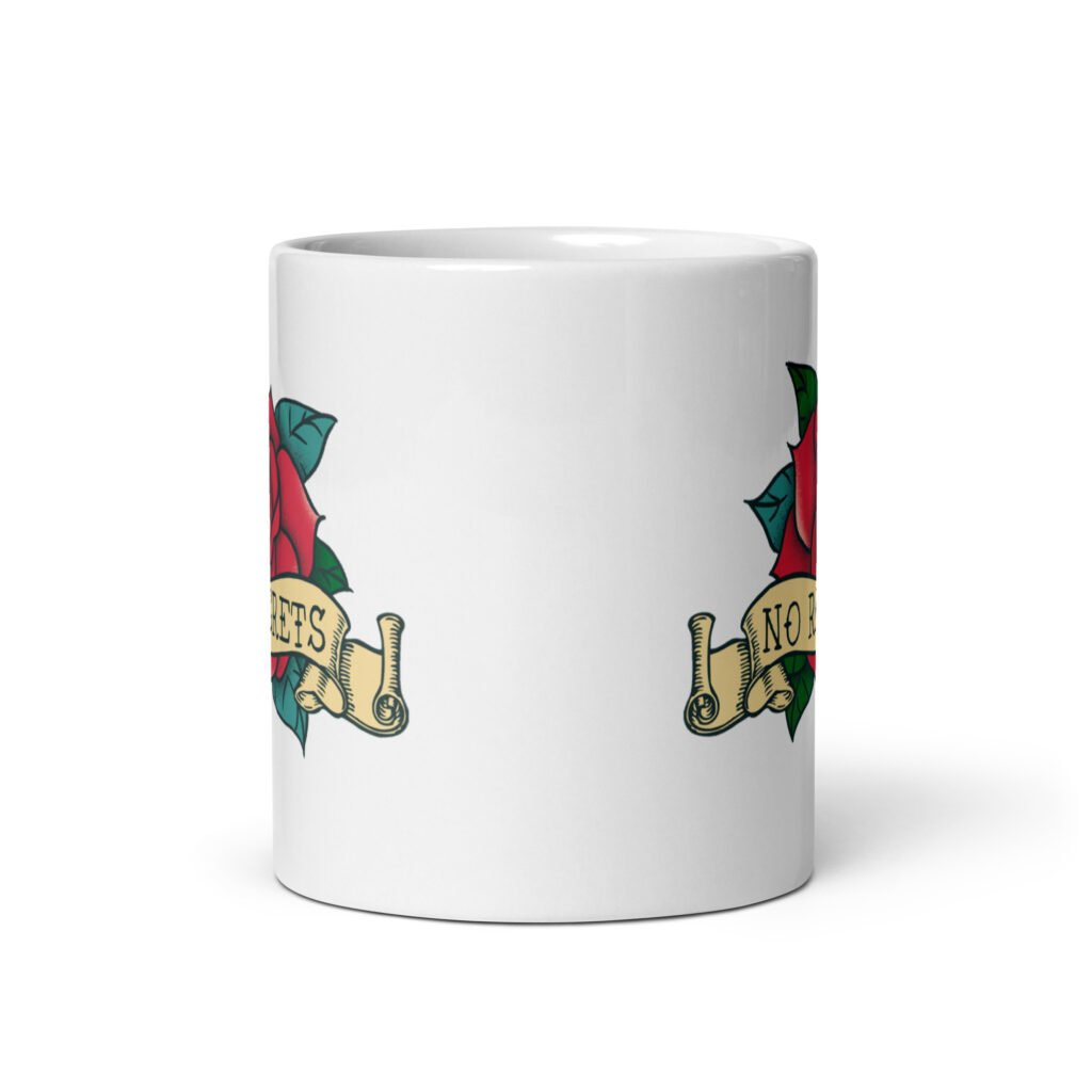 White ceramic coffee mug with funny image of an old school rose flash tattoo with the words 'No ragrets' intentionally misspelled. The graphics are printed on both sides of the mug.