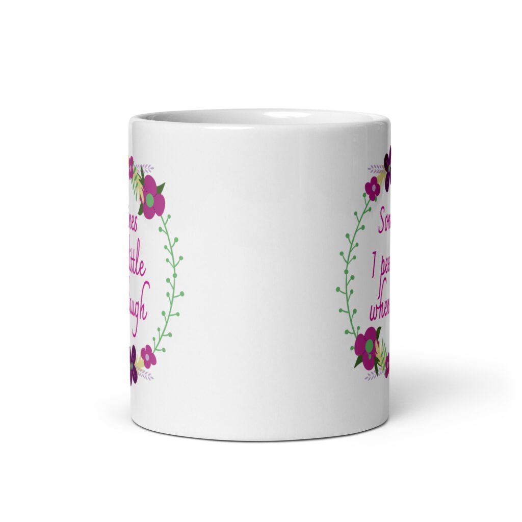 White ceramic coffee mug that has a colorful minimalistic style line drawing floral wreath with the text 'Sometimes I pee a little when I laugh' printed in the center of the wreath. The graphics are printed on both sides of the mug.