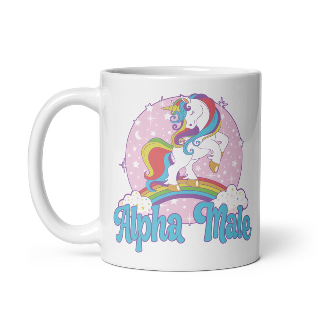 White ceramic mug with funny pastel rainbow unicorn graphics and the words Alpha Male printed on both sides.
