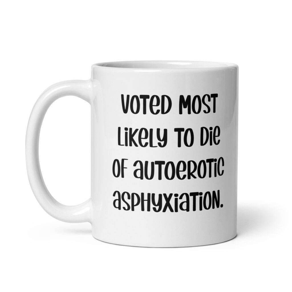 White ceramic mug with the text 'Voted most likely to die of autoerotic asphyxiation.' printed on both sides.