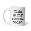 White ceramic mug with the text 'This is my second rodeo.' printed on both sides of the mug.