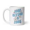 White ceramic coffee mug with a retro daisy and star design and the text 'Stop giving a fuck' printed on both sides.