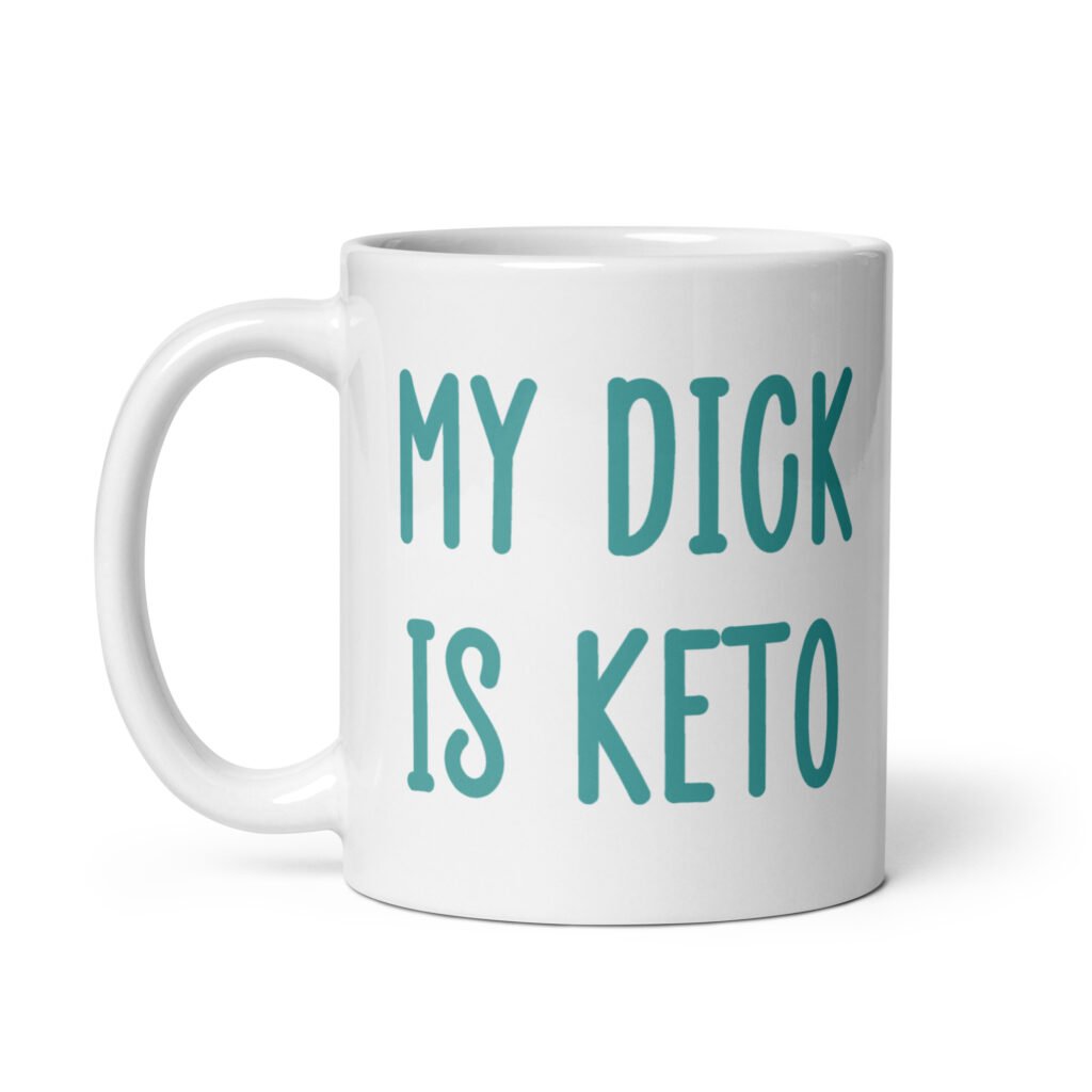 White ceramic coffee mug with the text 'My dick is keto' printed on both sides in turquoise font.