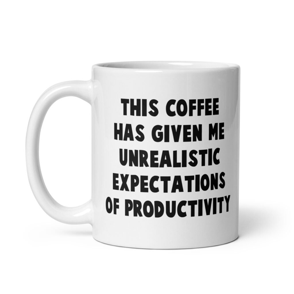 White ceramic coffee mug with the phrase 'This coffee has given me unrealistic expectations of productivity' printed on both sides.
