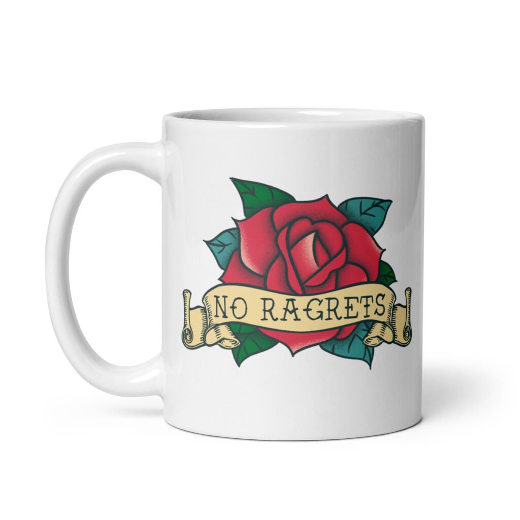 White ceramic coffee mug with funny image of an old school rose flash tattoo with the words 'No ragrets' intentionally misspelled. The graphics are printed on both sides of the mug.