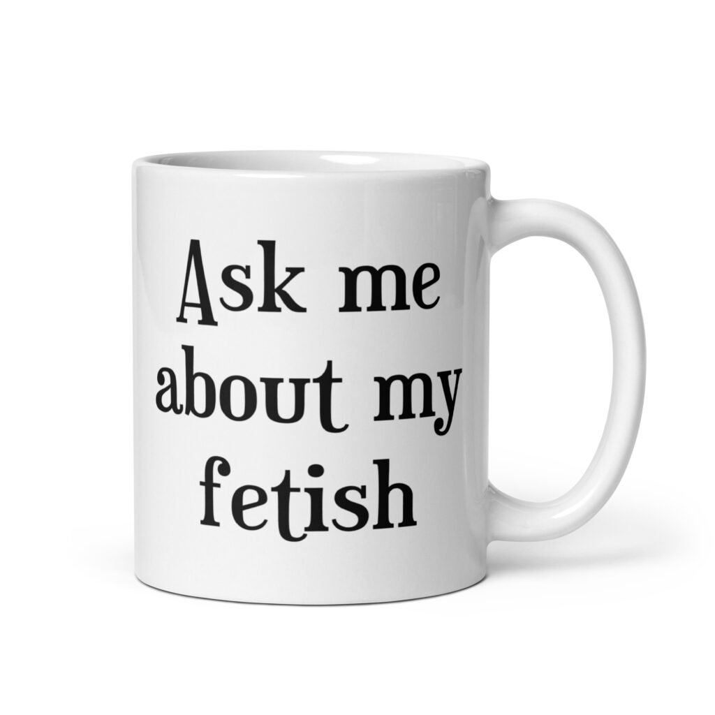 White ceramic mug with the text 'Ask me about my fetish' printed on both sides.
