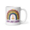 White ceramic mug with an image of a boho style rainbow. There is an upside down cross in the center arch of the rainbow and the text 'Love like Lucifer' printed under. The graphics are printed on both sides of the mug.
