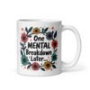 White ceramic mug with a multi color floral wreath design printed on both sides. The words 'One mental breakdown later...' are printed in the center of the wreath.