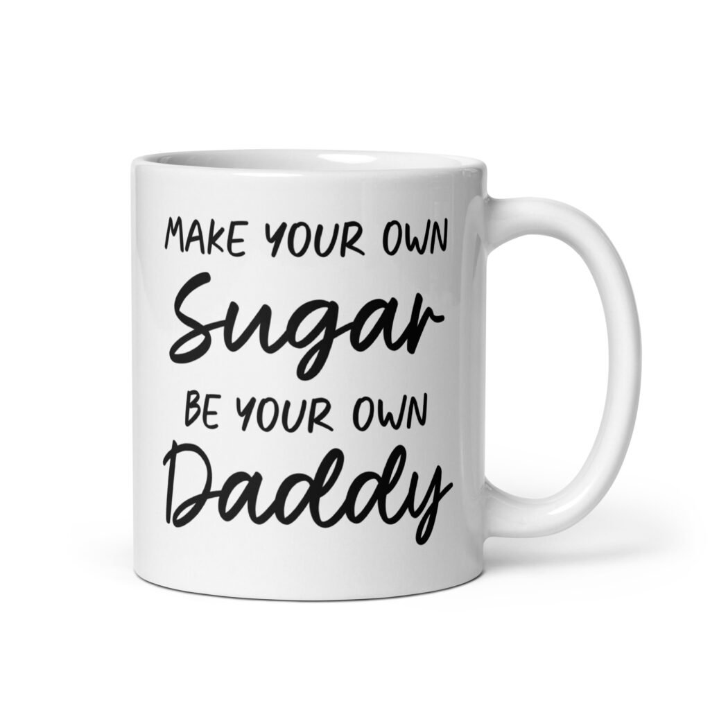 White ceramic coffee mug with the text 'Make your own sugar Be your own Daddy' printed on both sides.