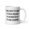 White ceramic mug with the phrase 'Some days it's hard to focus because I'm distracted by my own cleavage' printed on both sides.