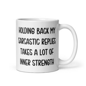 White ceramic mug with the phrase 'Holding back my sarcastic replies takes a lot of inner strength' printed on both sides of the mug.