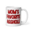 White ceramic mug with the text 'Mom's favorite asshole' printed in red on both sides of the mug.