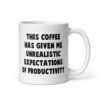 White ceramic coffee mug with the phrase 'This coffee has given me unrealistic expectations of productivity' printed on both sides.