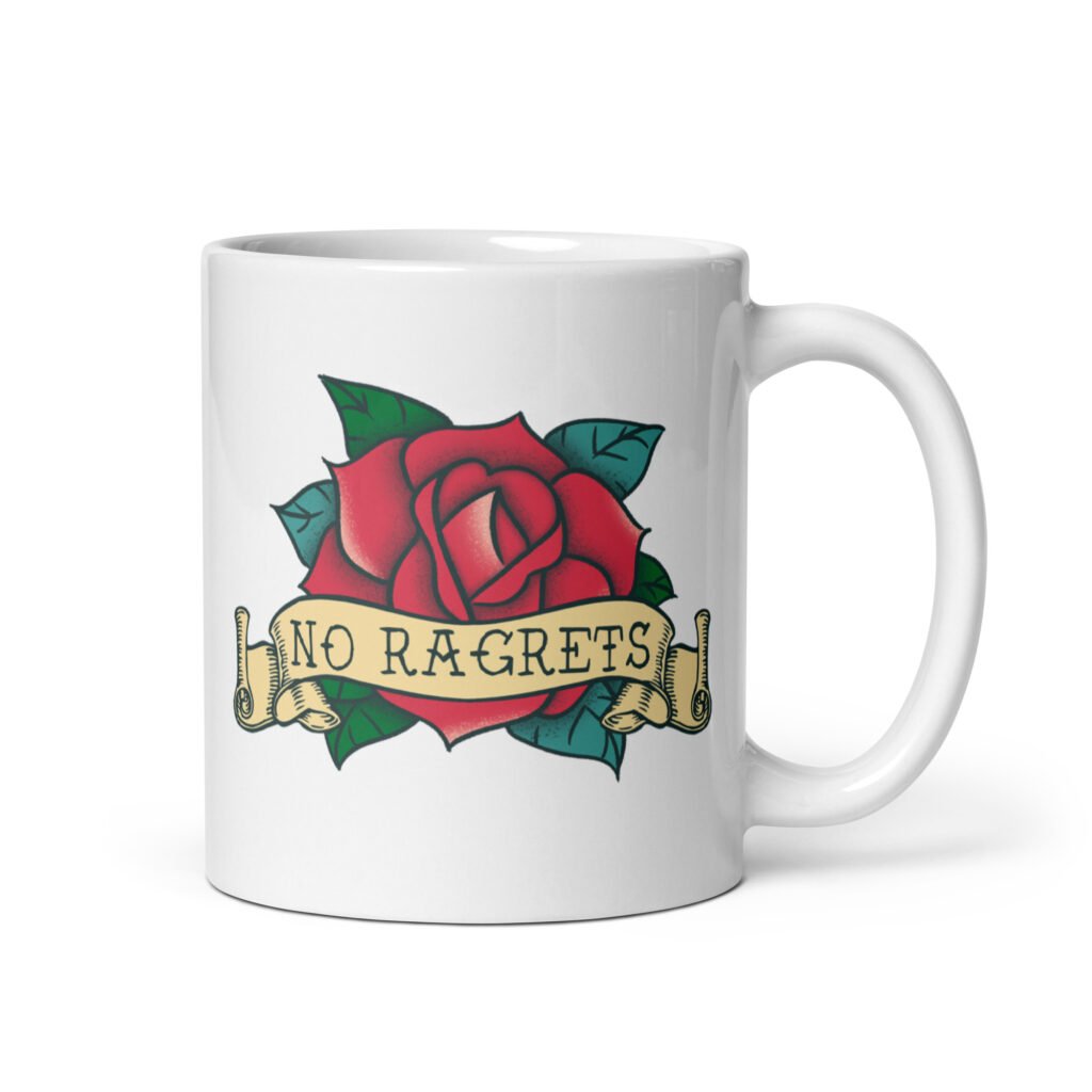 White ceramic coffee mug with funny image of an old school rose flash tattoo with the words 'No ragrets' intentionally misspelled. The graphics are printed on both sides of the mug.