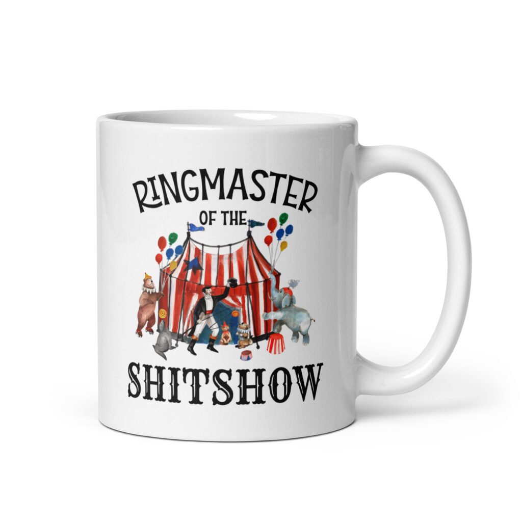 White ceramic coffee mug with a circus theme graphic and the text 'Ringmaster of the Shitshow' printed on both sides.
