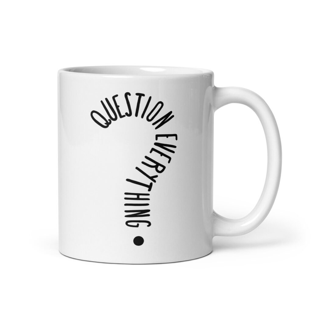 White ceramic coffee mug with the text 'Question everything' printed on both sides. The words are in the shape of a question mark.