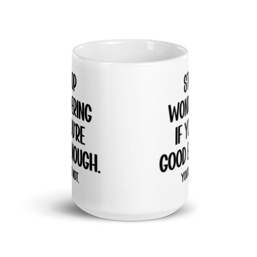 White ceramic mug with the phrase 'Stop wondering if you're good enough. You're not.' printed on both sides of the mug. The words 'You're not' are smaller then the rest.