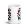 White ceramic mug with a multi color floral wreath design printed on both sides. The words 'One mental breakdown later...' are printed in the center of the wreath.