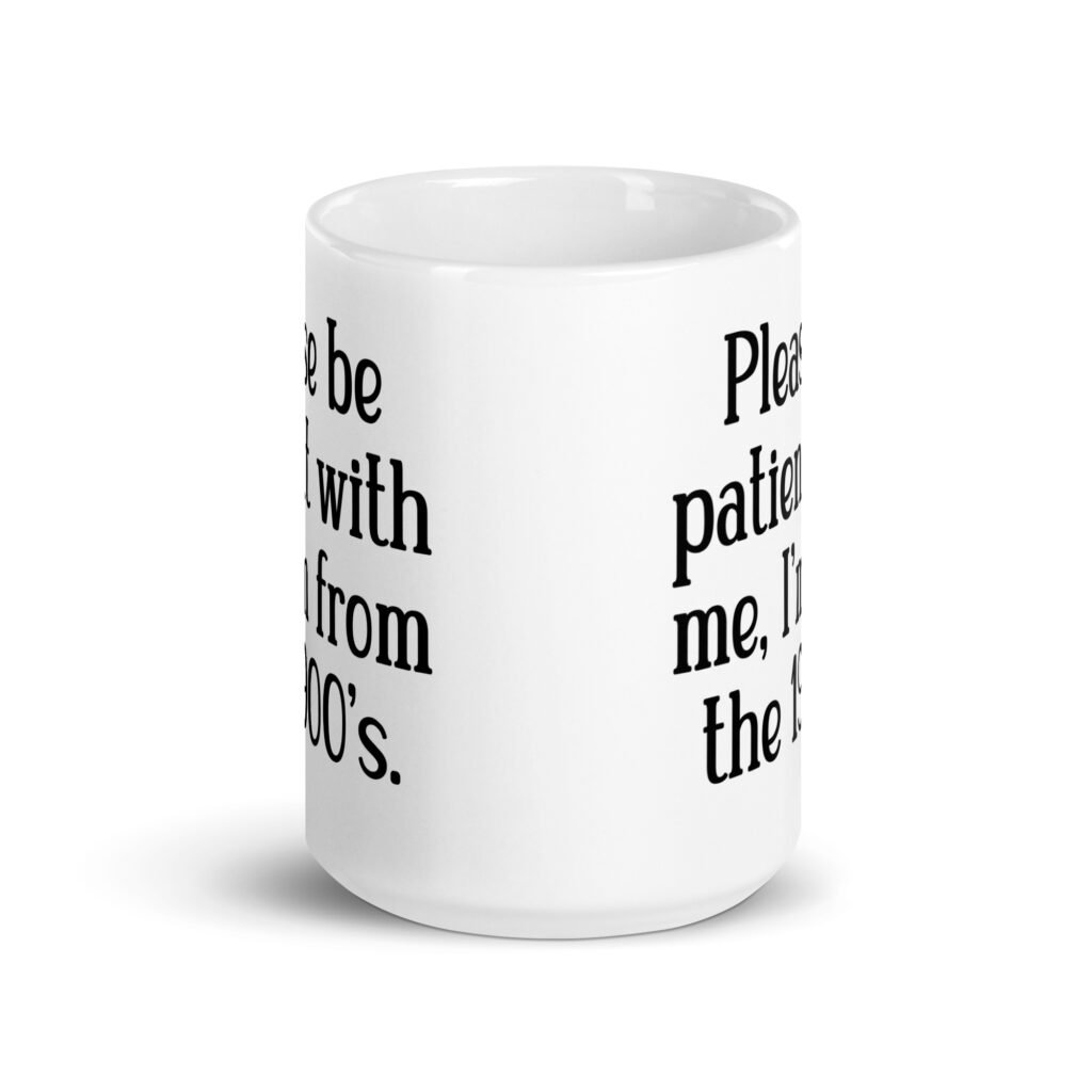 White ceramic mug with the text 'Please be patient with me, I'm from the 1900's' printed on both sides.
