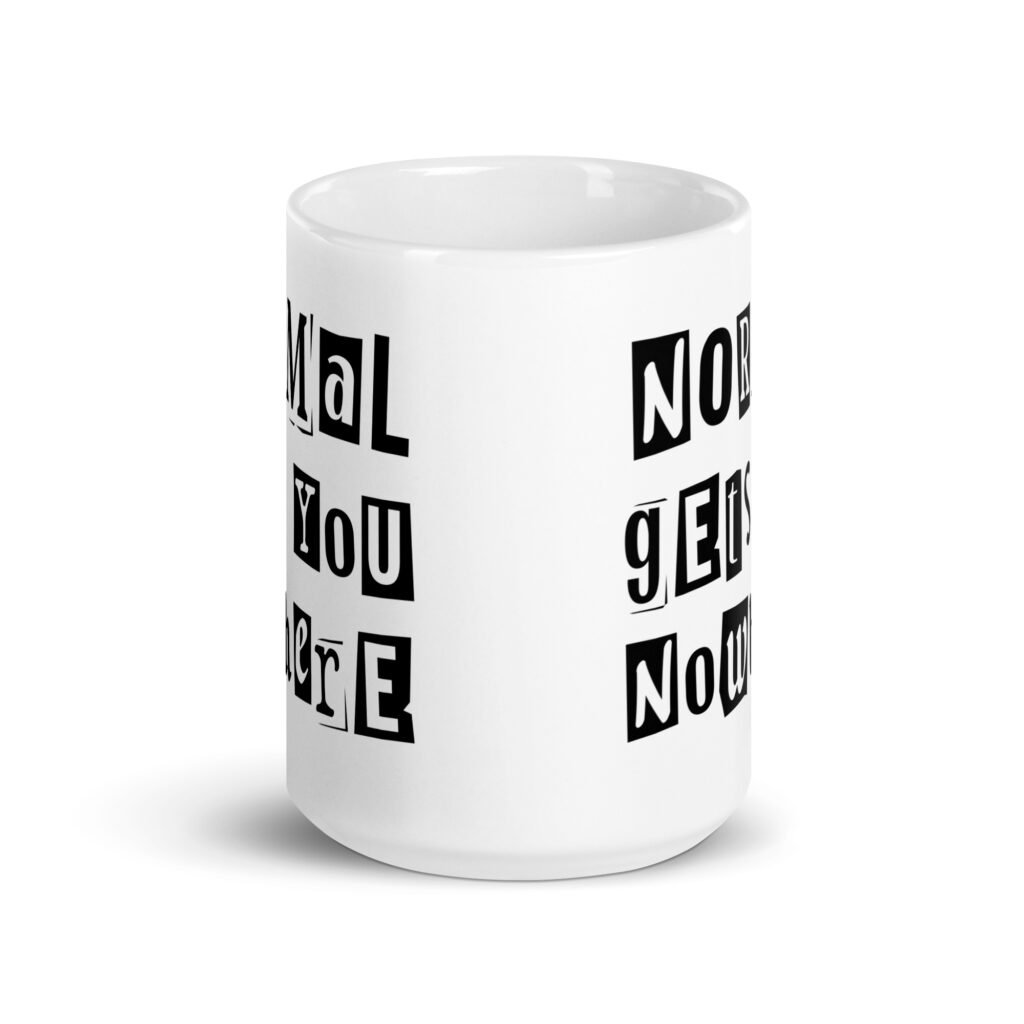 White ceramic coffee mug with the phrase 'Normal gets you nowhere' printed on both sides.