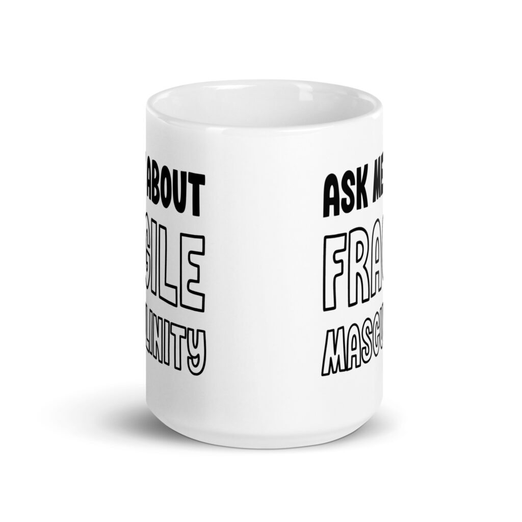 White ceramic coffee mug with the text 'Ask me about fragile masculinity' printed on both sides.