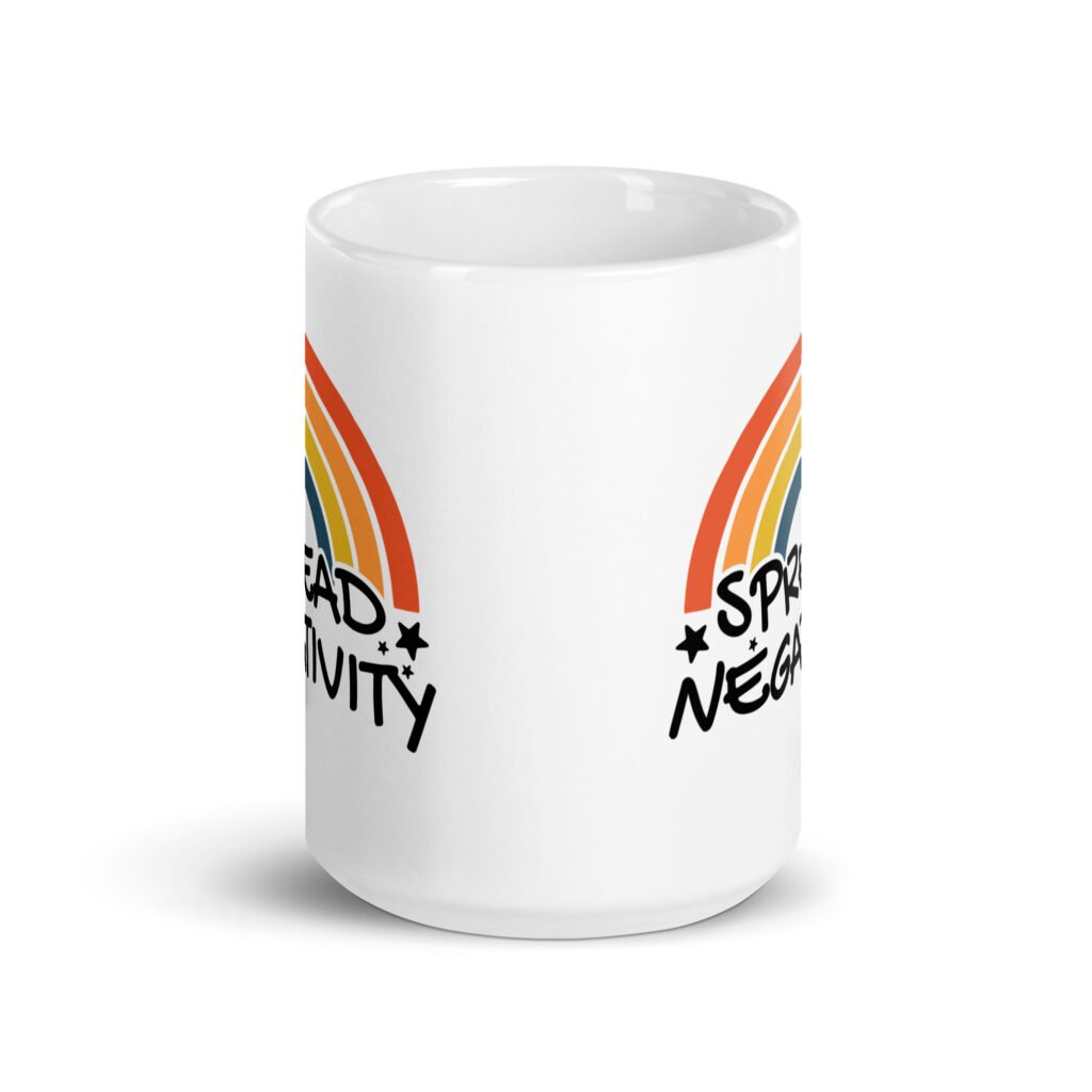 White ceramic coffee mug with a graphic of a rainbow and the words 'Spread negativity' printed on both sides.