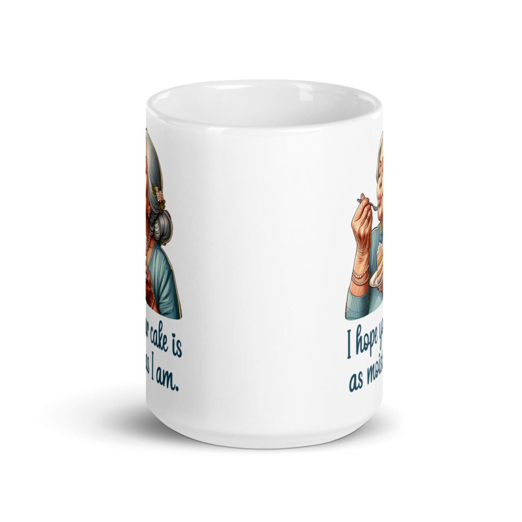White ceramic coffee mug with an image of grey haired older woman enjoying a bite of a piece of cake with the words 'I hope your cake is as moist as I am' printed on both sides.