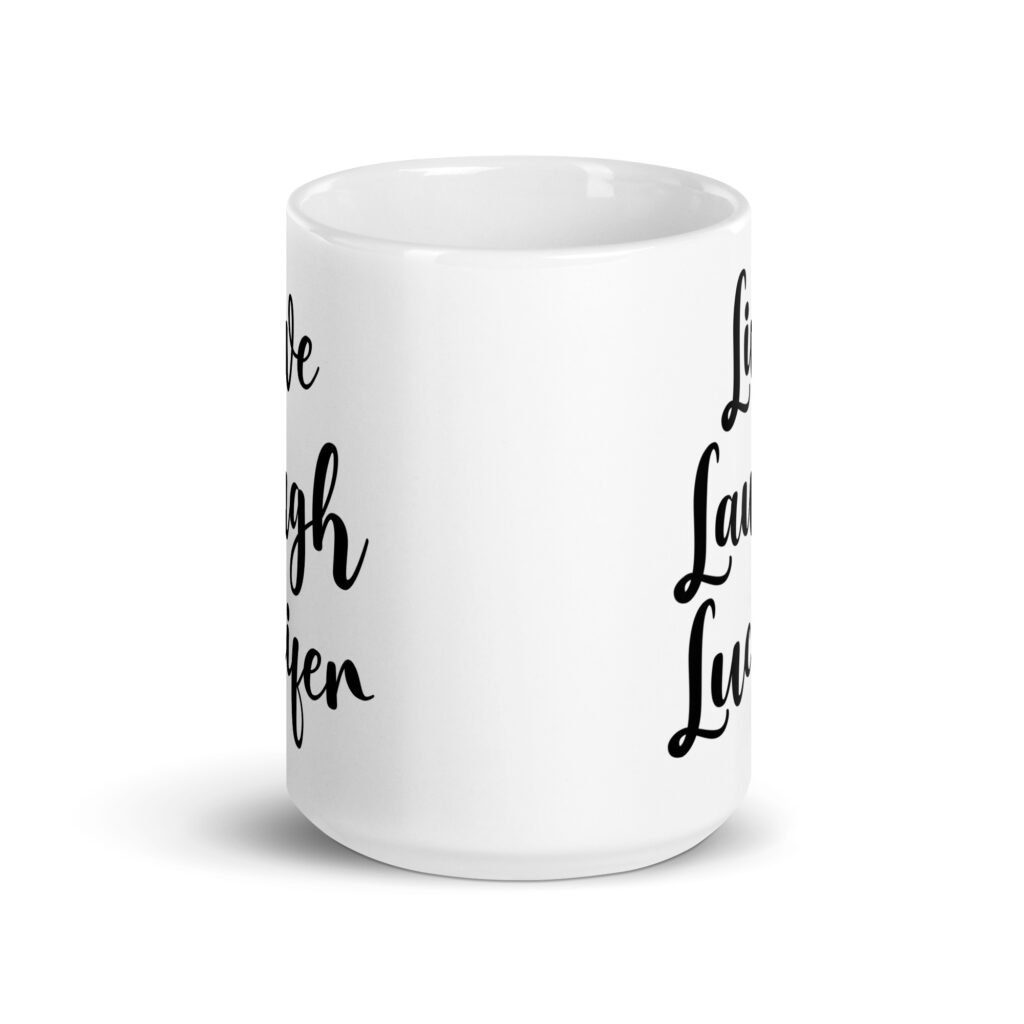 White ceramic coffee mug with the parody phrase 'Live, Laugh, Lucifer' printed on both sides.