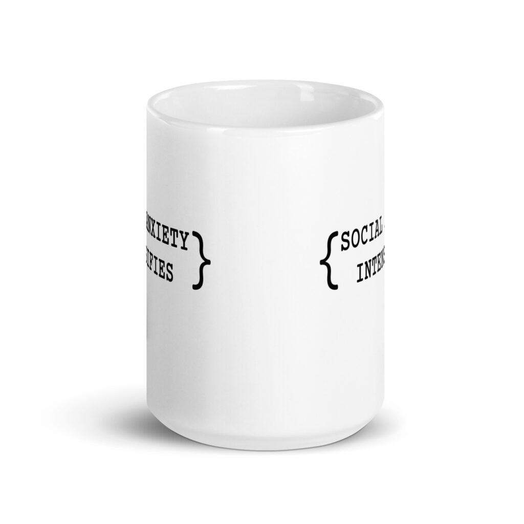 White ceramic coffee mug with the text 'Social anxiety intensifies' printed on both sides.
