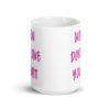 White ceramic coffee mug with the words 'Women don't owe you shit' printed on both sides in pink.
